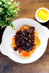 Black bean sauce served over carrot noodles