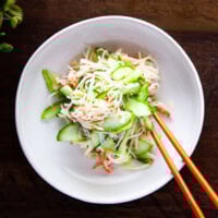 Korean cucumber crab salad served on a white plate with chopsticks