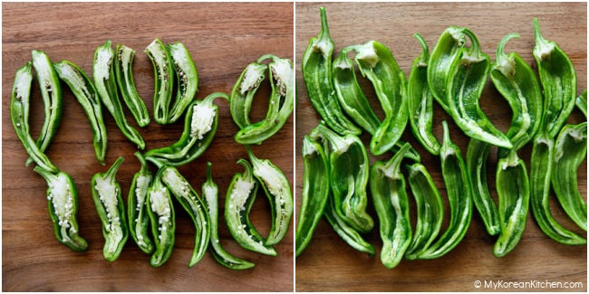 Halved green chili peppers on a cutting board, with seeded peppers on the left and deseeded peppers on the right.