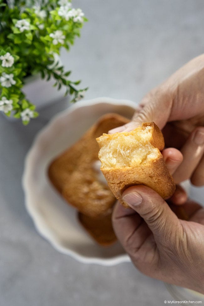 breaking a piece of butter tteok by hand