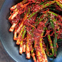 pa kimchi served neatly on a shallow black bowl