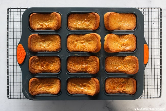 baked butter tteok cooling in the pan on a wire rack