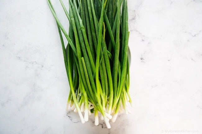 cleaned green onions on a white background
