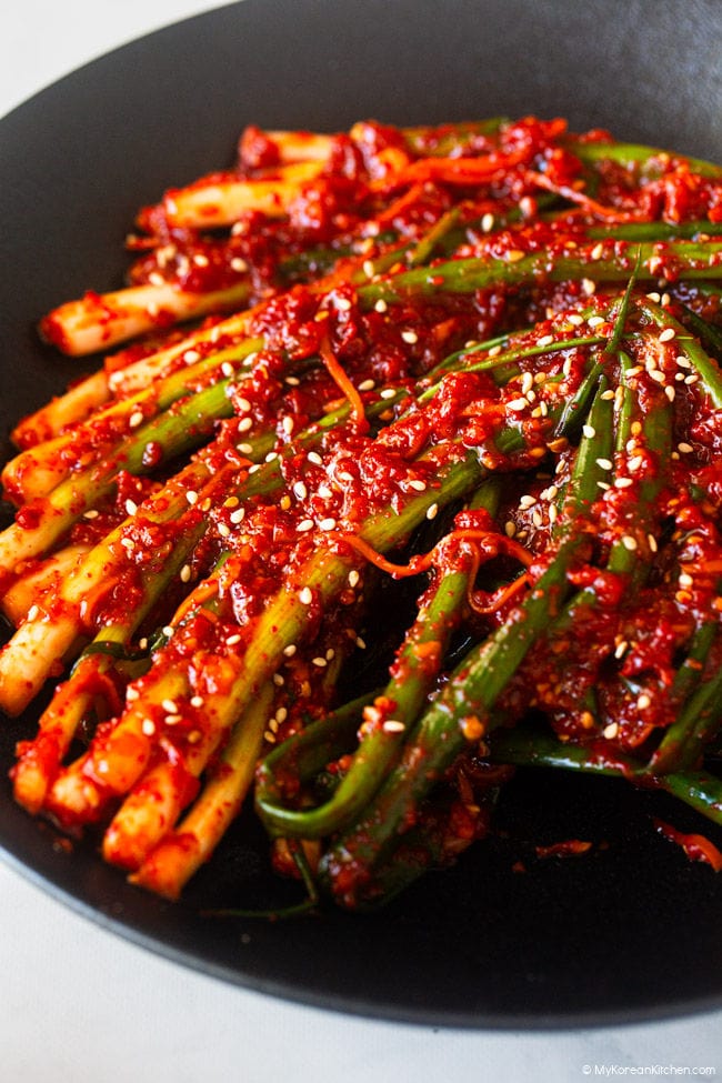 Close-up of pa kimchi served in a shallow black bowl