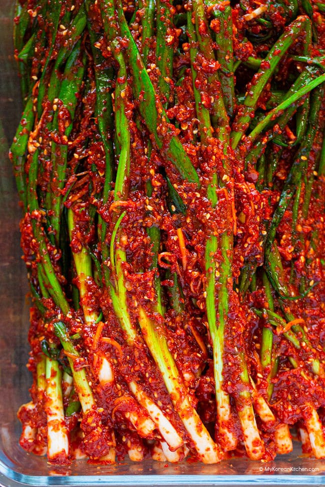 freshly made pa kimchi stored in a glass container