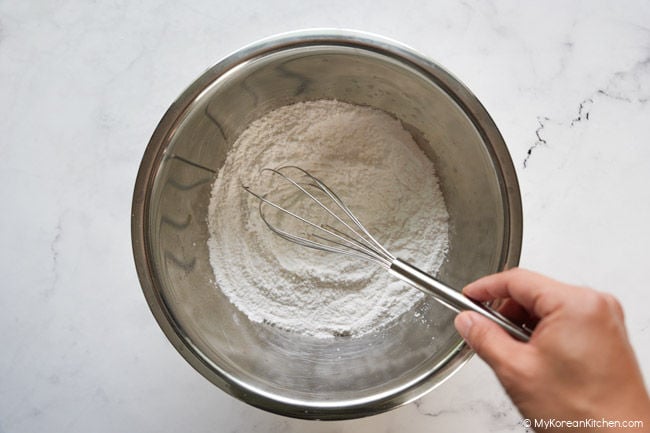 mixing the dry ingredients for butter tteok in a large bowl