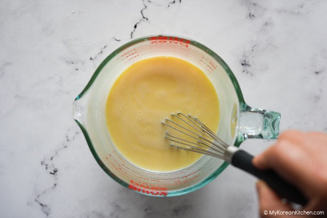 whisking the wet ingredients in a jug for butter tteok