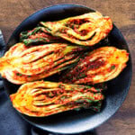 Homemade bok choy kimchi served in a black bowl
