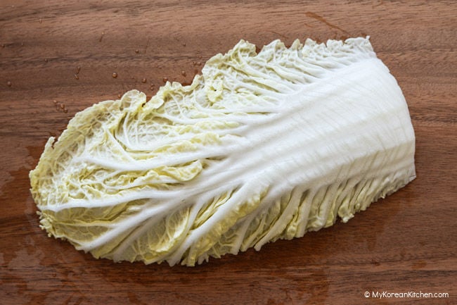 Napa cabbage leaves with shallow cuts made through the thick stems.