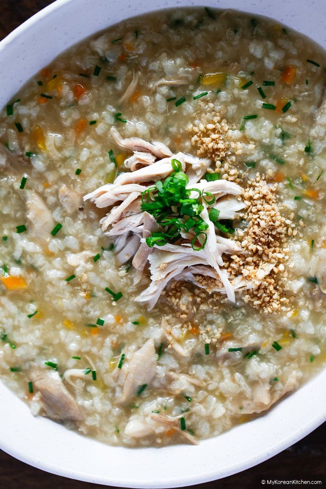 Close-up of dakjuk showing tender chicken and soft rice in the finished porridge